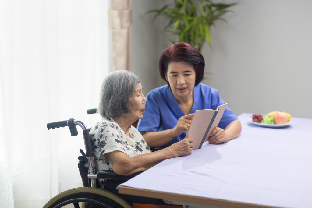 Elderly woman reading aloud a book for dementia therapy